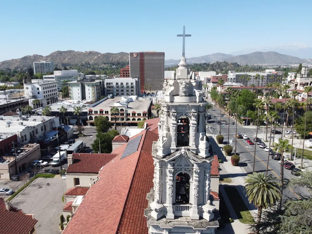 Downtown Riverside from above, with its historic church tower and the mountains behind