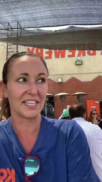 Krista Goodsitt smiling at an outdoor event in a blue K9 Youth Alliance shirt